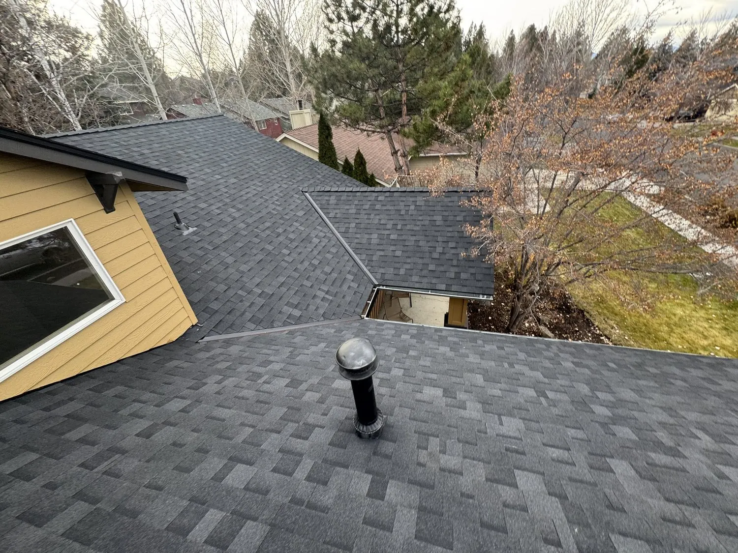 Completed shingle roof with new pipe flashing
