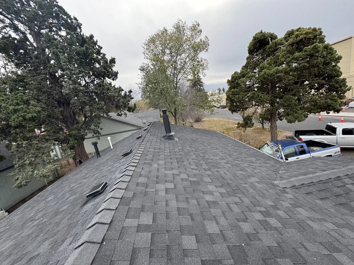 Completed shingle roof with ridge cap and vent