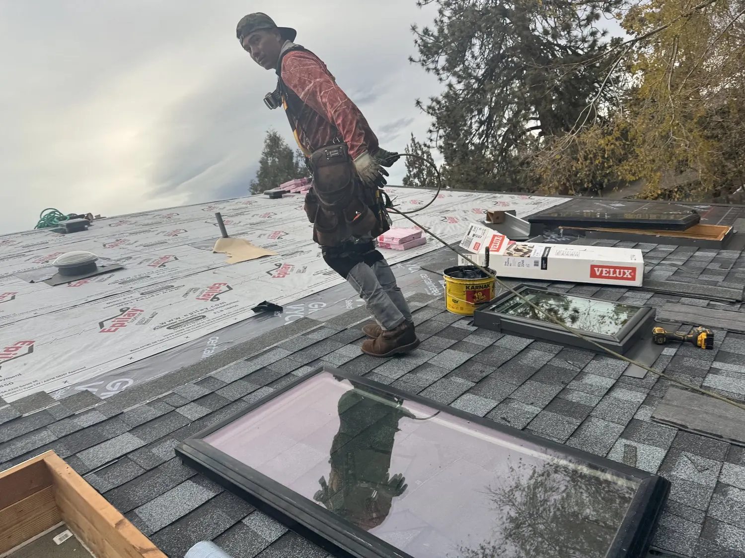 Roofer flashing a skylight