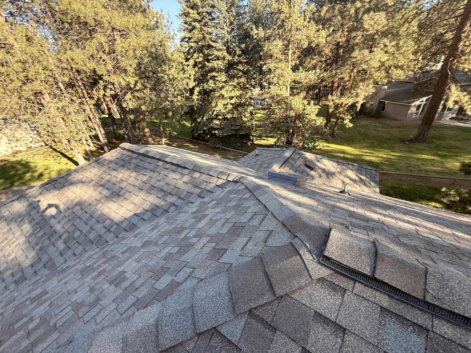Finished laminated shingles meeting at a hip