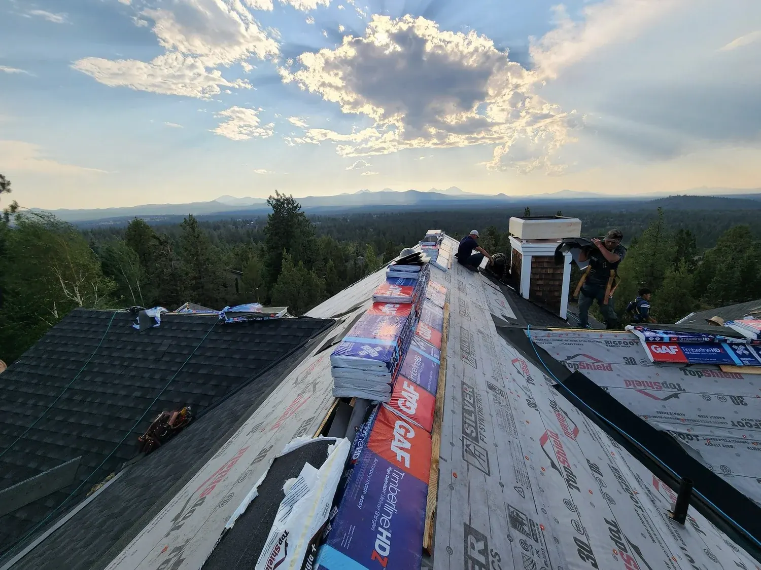 Underlayment going down with mountains on the horizon
