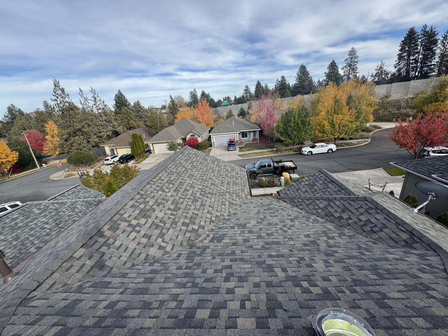 Finished architectural shingle roof overlooking a residential street