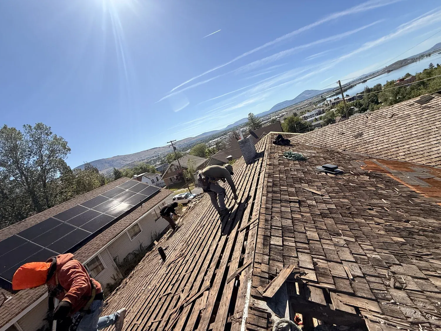 Crew tearing off an old wood roof